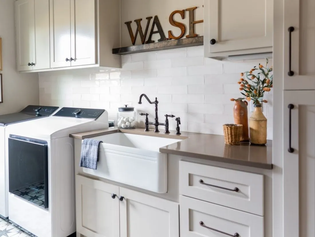 Custom farmhouse laundry room cabinets with apron sink in Sherwood, AR
